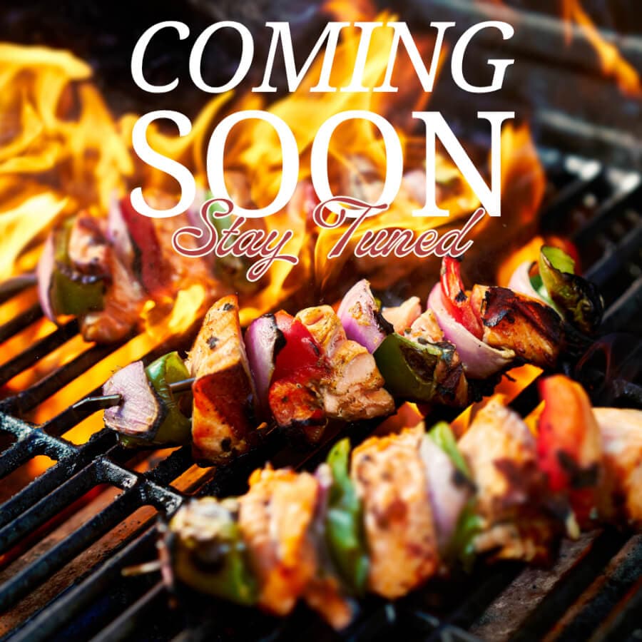 Grilled skewers with meat and veggies over a fiery grill, featuring text that says "COMING SOON, Stay Tuned."
